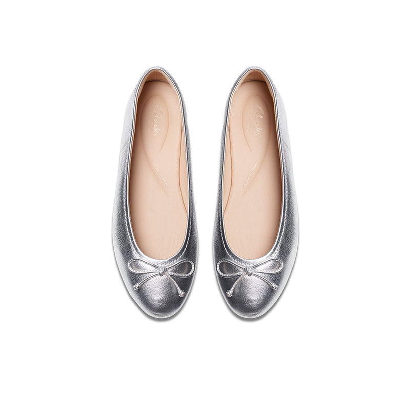 Pair of silver leather loafer flats with bow on the toe