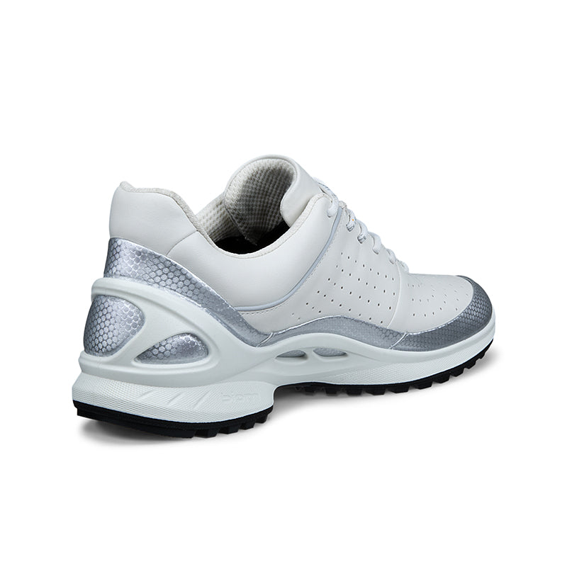 White lace-up sneakers with perforated toe and gray heel panel, side view