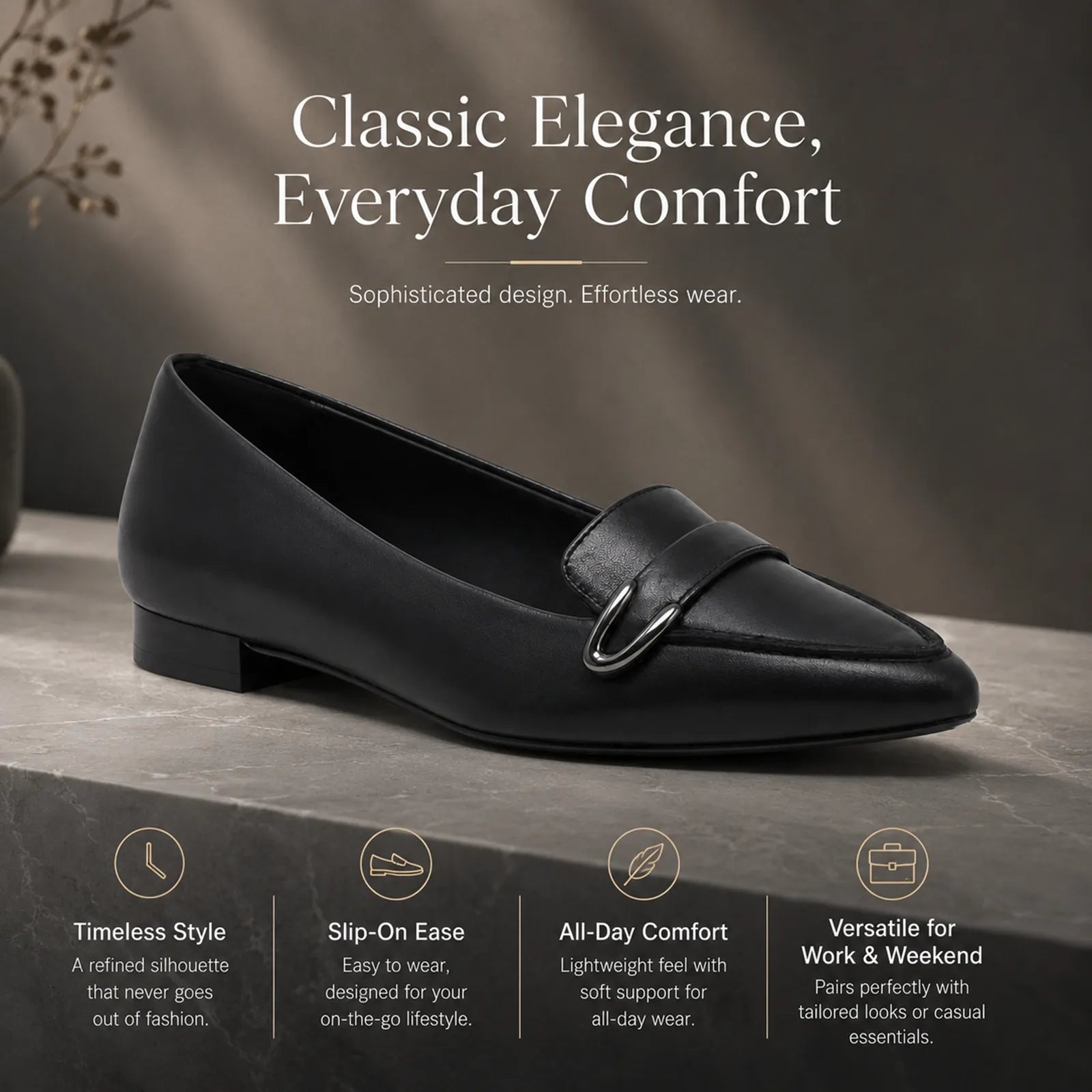 Women's black leather loafer with front buckle detail and flat low heel
