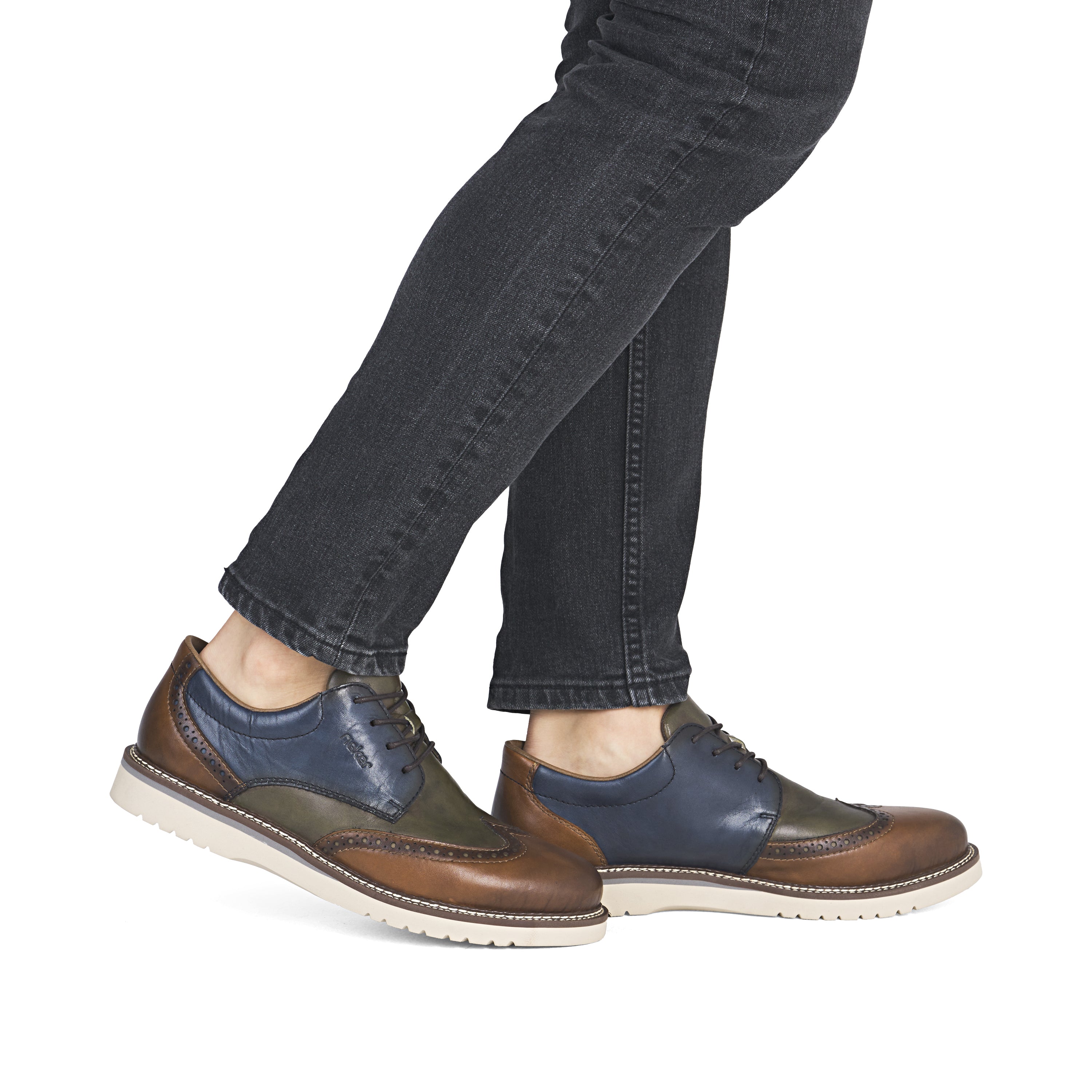 Men's brogue leather lace-up shoes, blue and brown colorblock, on feet with jeans.