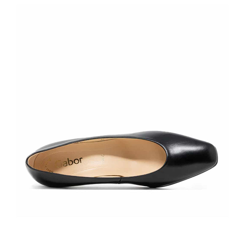 Black leather slip-on heel with pointed toe, showing beige insole interior