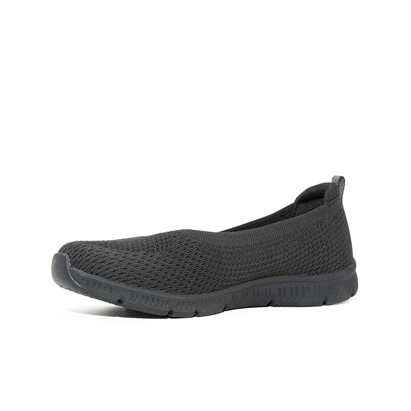 Women's black mesh slip-on sneaker side view with rubber sole
