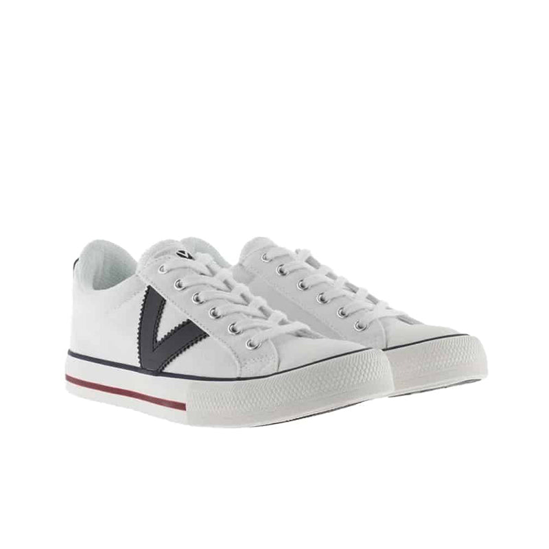 White low-top sneakers with lace-up, navy V side logo and red edge stripe