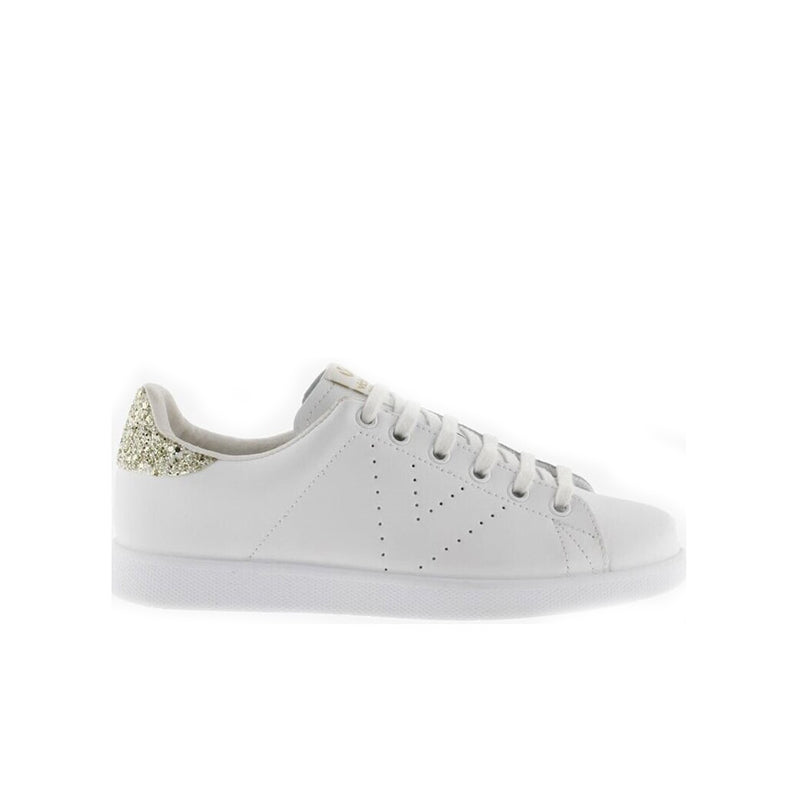 White low-top sneaker side view with perforated toe and gold glitter heel trim