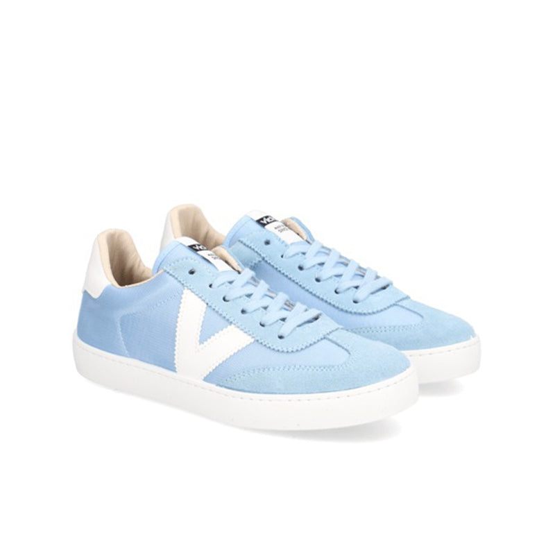 Light blue low-top lace-up sneakers with white side panels and white rubber sole