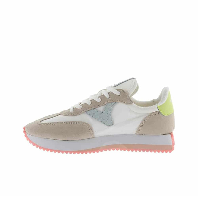 Beige low-top sneakers with white laces, colored side panels, and pink sole