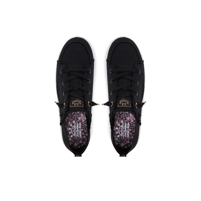 Black canvas sneakers with lace-up front and floral patterned inner lining