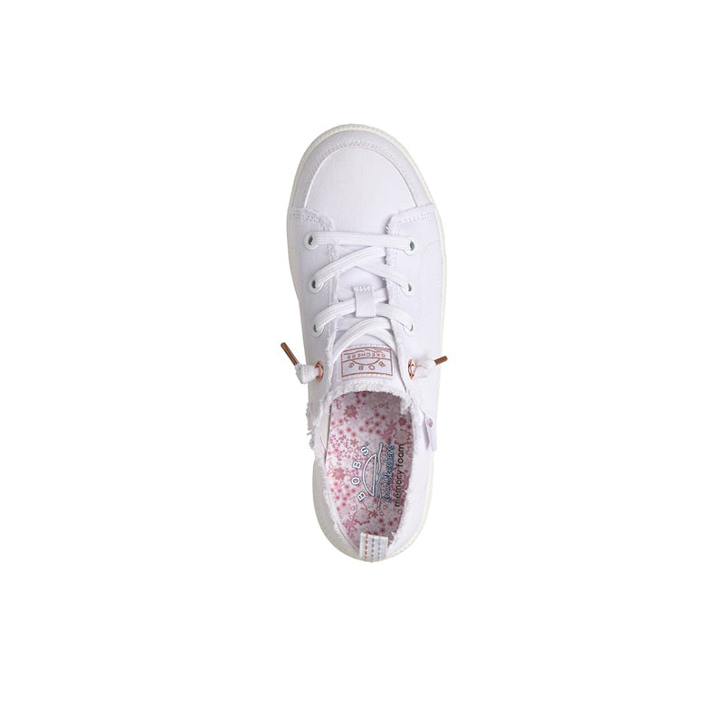 White canvas sneaker with lace-up front and visible floral patterned inner lining