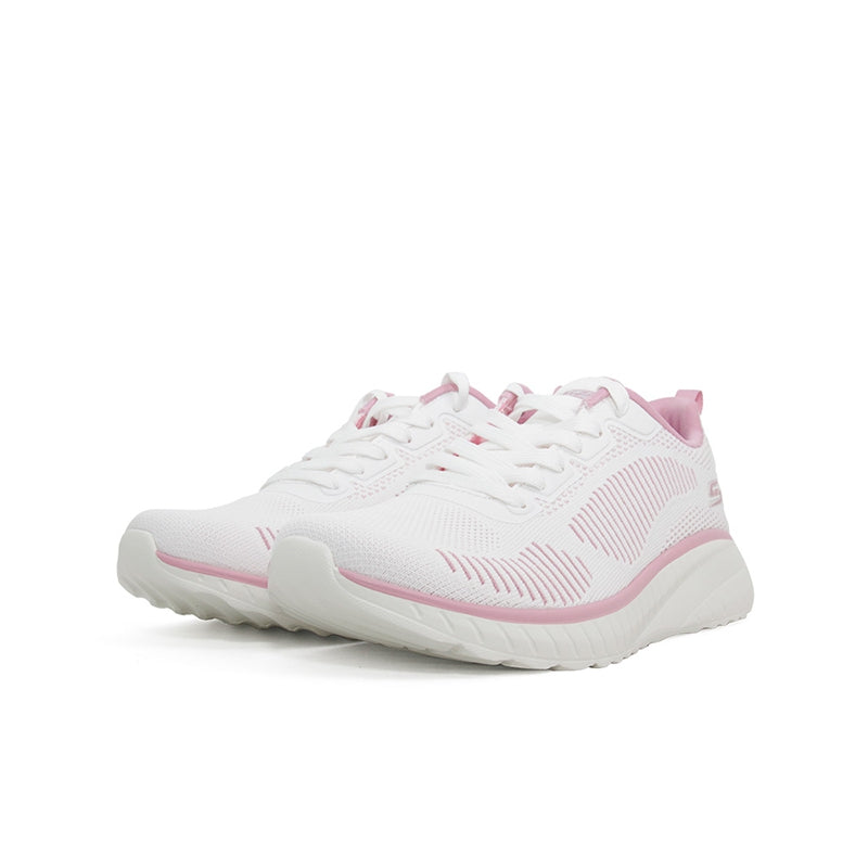Women’s white textile sneaker with pink accents, lace-up closure and textured rubber outsole