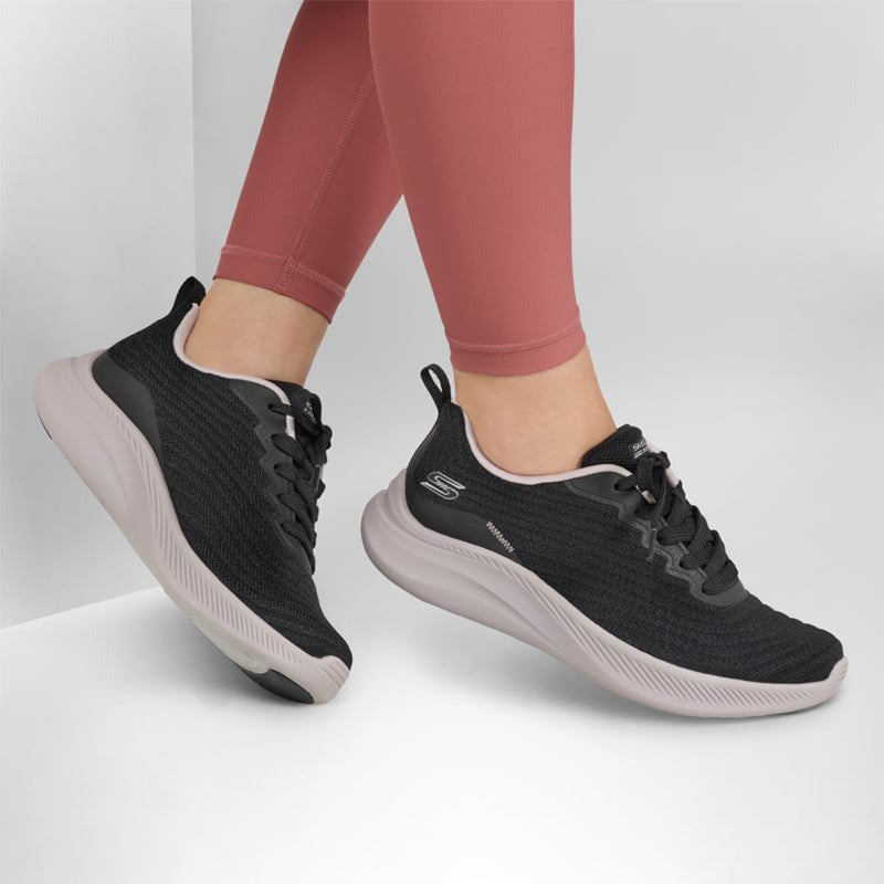 Women's black lace-up knit sneakers with padded collar and white sole