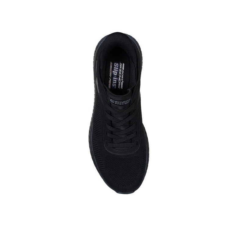 Men's black slip-on sneakers, side view with lace front and padded collar