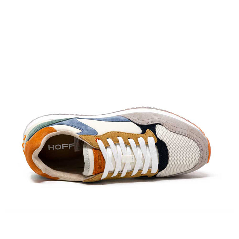 Men's leather sneakers side view with white laces and multicolor panels; black heel tab