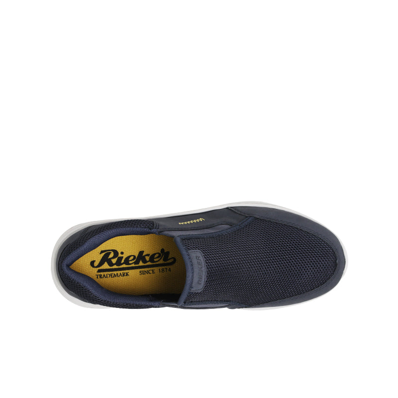 Women's slip-on sneaker interior view with logo patch and dark blue lining