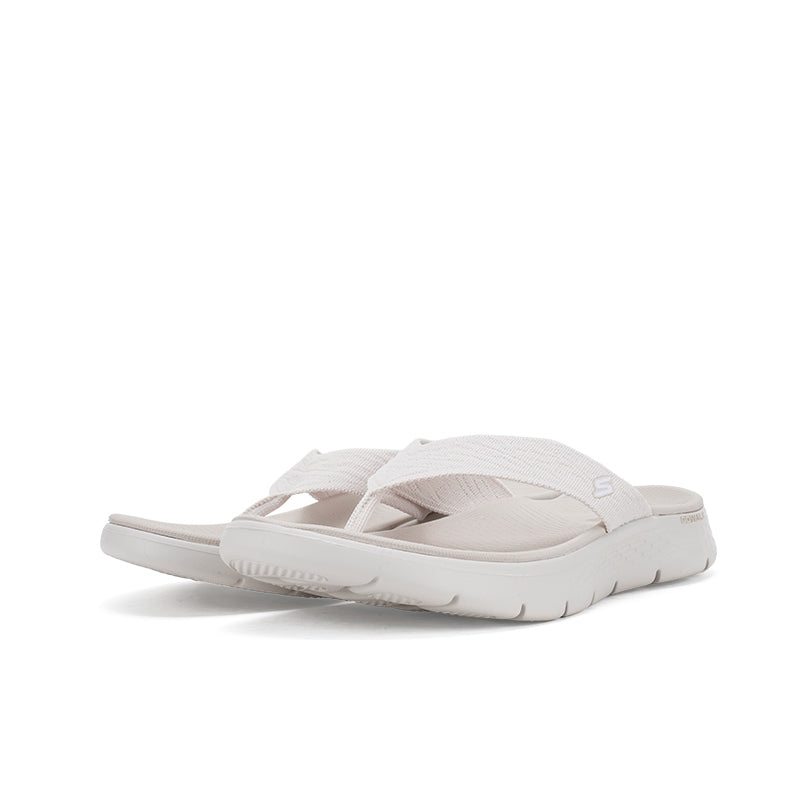 Women's slide sandal showing heel and treaded sole, light neutral