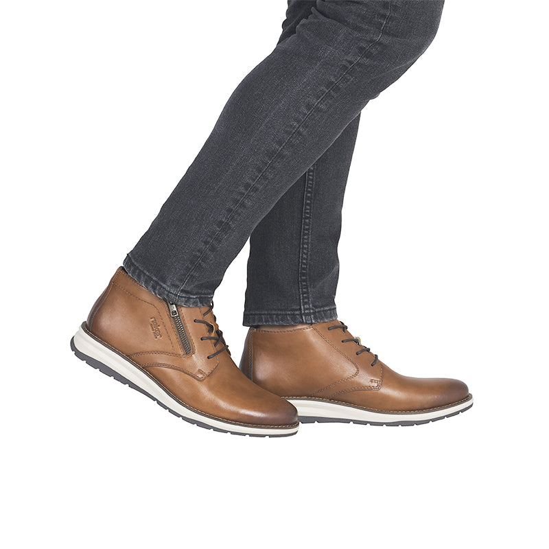 Men's brown leather zip boots with lace-up, worn with dark jeans