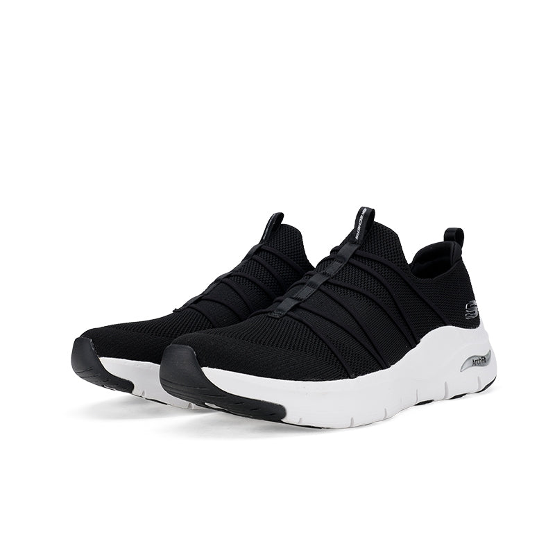 Pair of black textile women's sneakers with white midsoles and two hook-and-loop straps