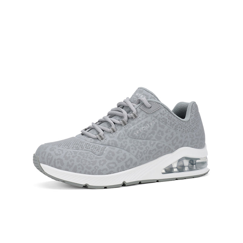 Grey low-top sneakers side view with lace-up design and visible air-cushion sole