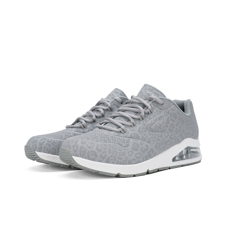 Grey women's sneakers angled side view with lace-up and air-cushion heel