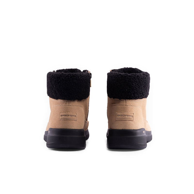 Pair of beige boots with black rear collar, lace-up front, and dark rubber heel