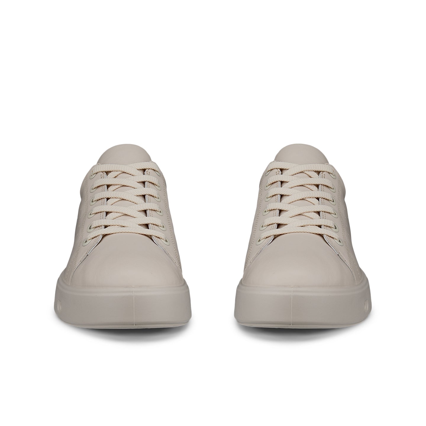 Beige lace-up sneakers, front view, with patterned eyelets and rounded toe