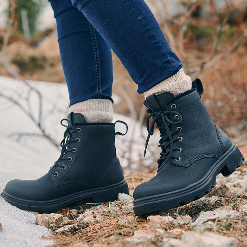 Dark leather lace-up ankle boots worn with jeans; chunky heel and rugged lug outsole