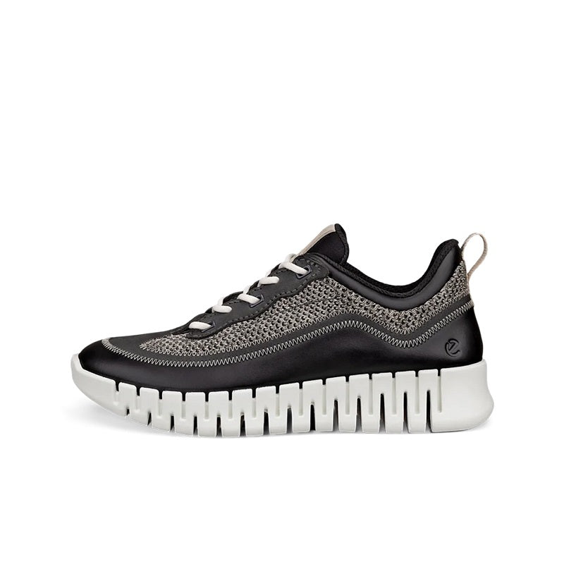Black lace-up sneaker with textile upper, low profile, and chunky white ribbed sole