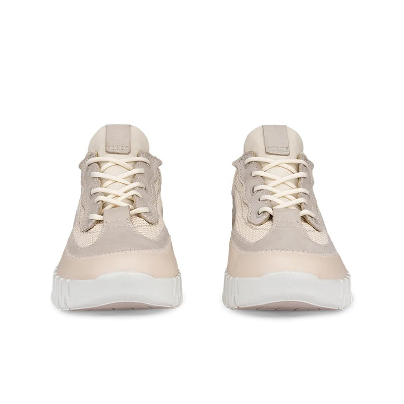 Pair of light beige lace-up sneakers with chunky white ribbed soles