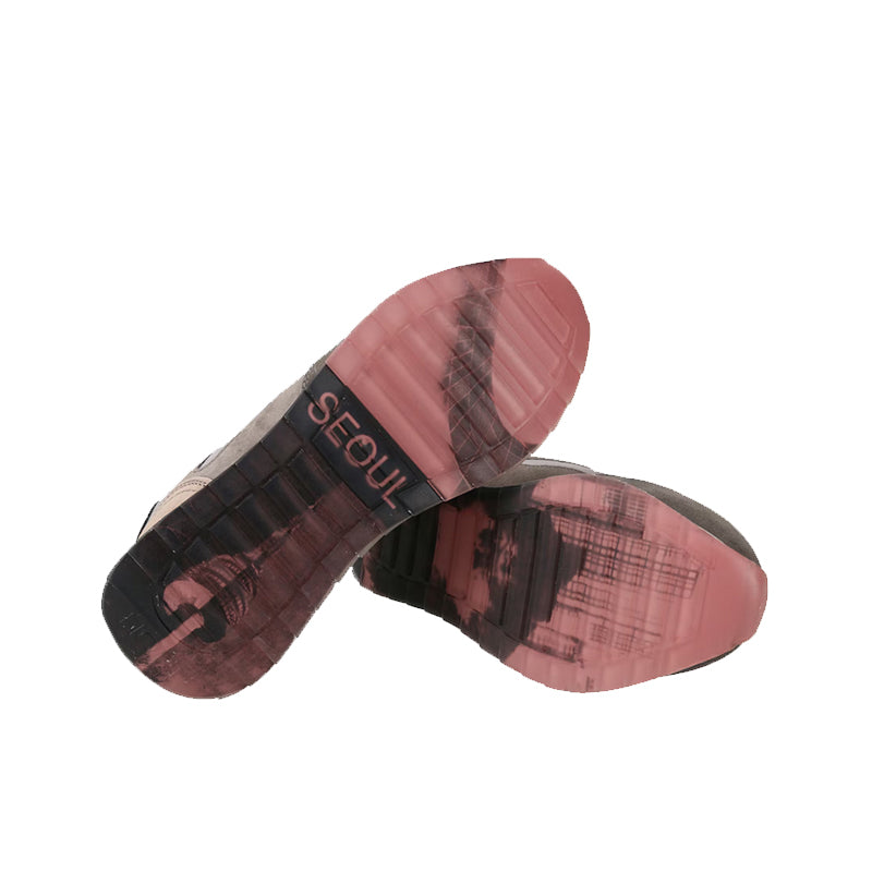 Sneaker outsole tread with pink rubber and 'Seoul' text on one shoe