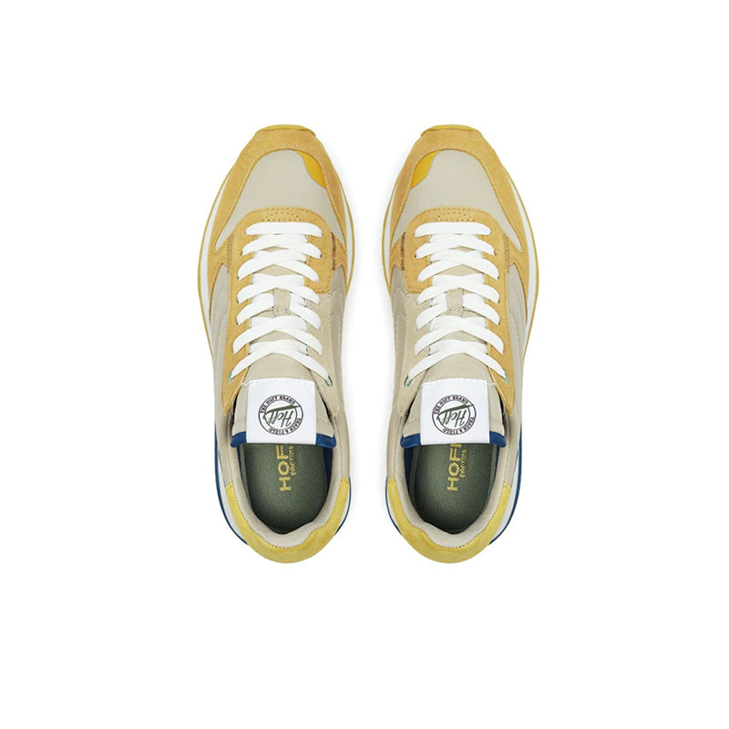 Pair of men's casual sneakers with cream uppers and white laces, yellow trim