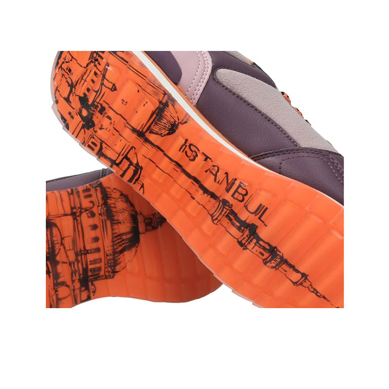 Orange and dark gray sneaker outsole with graphic tread and 'ISTANBUL' text