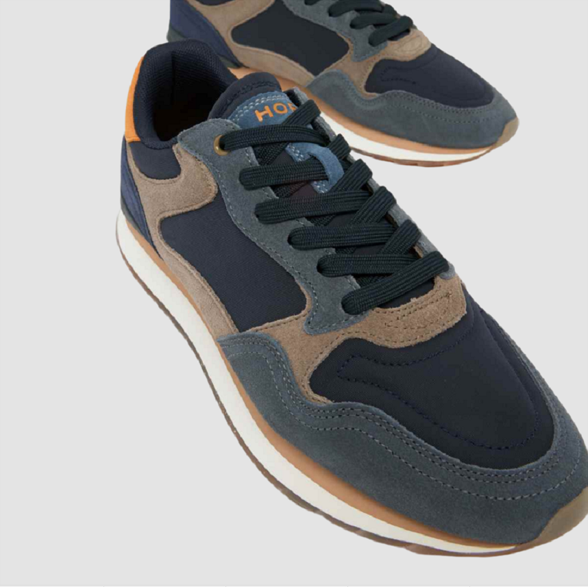 Men's lace-up sneakers with navy upper, tan panels, dark laces, and white rubber sole