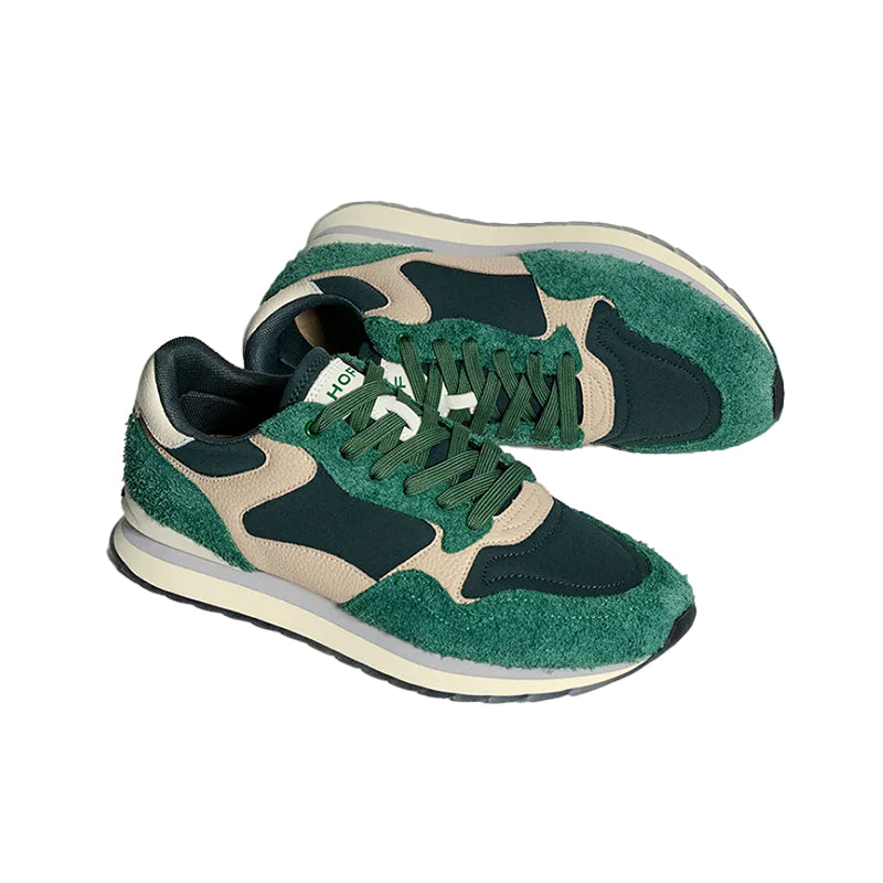 Men's green sneakers with black heel, beige overlays, and teal laces