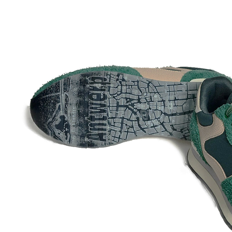 Men's sneaker outsole with green upper edge and textured black tread