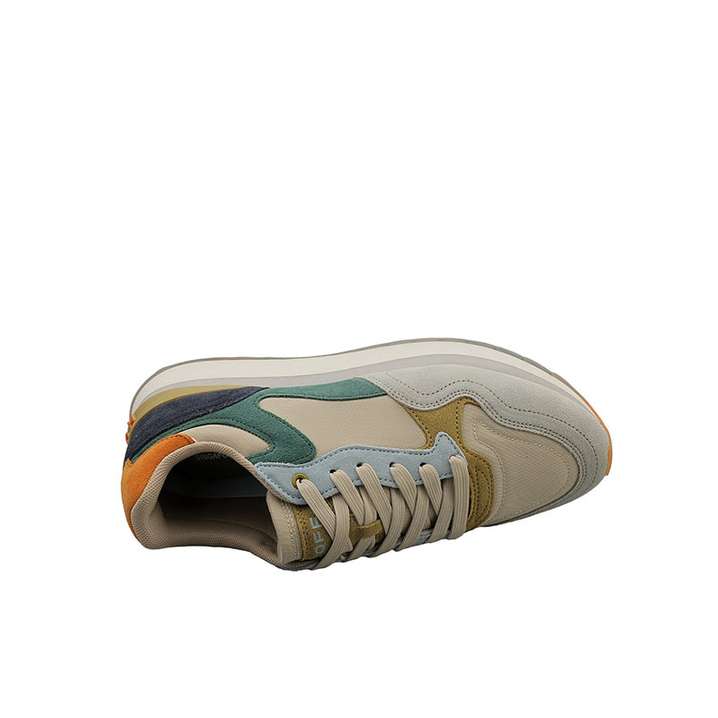 Men's leather sneakers toe and laces view, cream with teal overlays and orange trim.