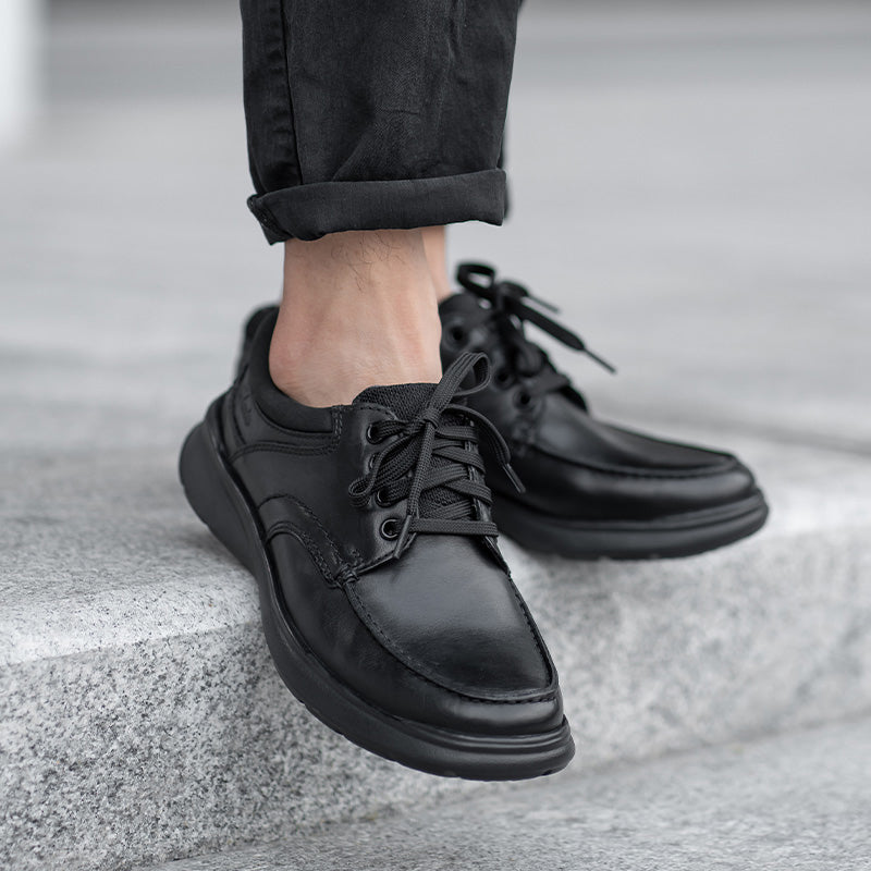 Men's black leather lace-up dress shoes with cushioned collar and textured sole