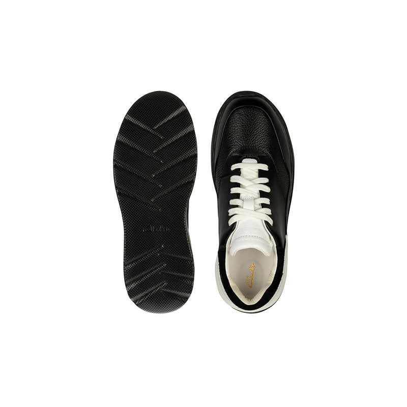 Pair of black lace-up sneakers: outsole tread view and side view with white laces