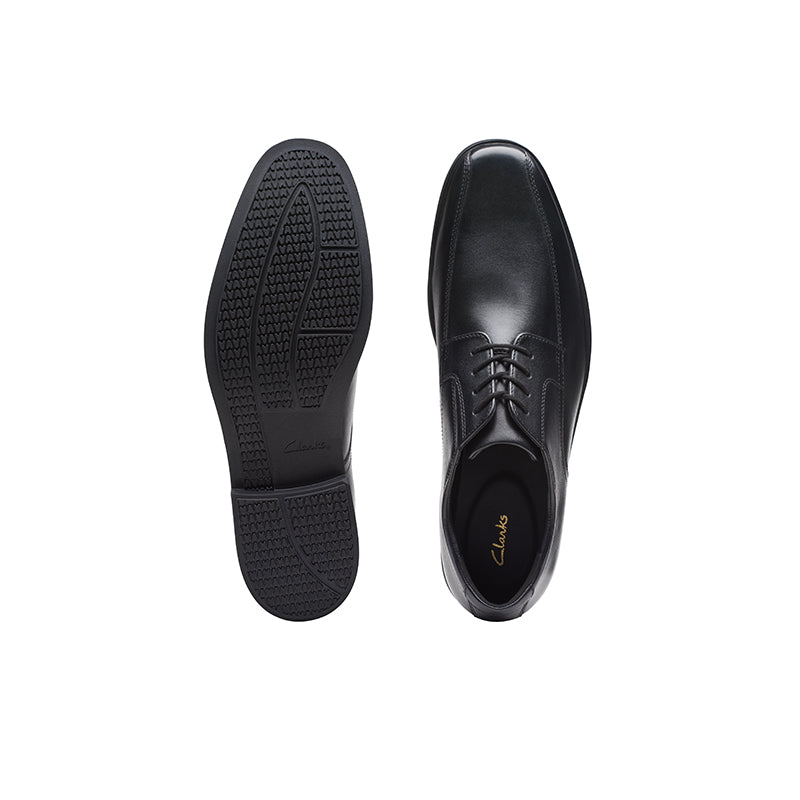 Pair of black leather dress shoes for men, side view and outsole view