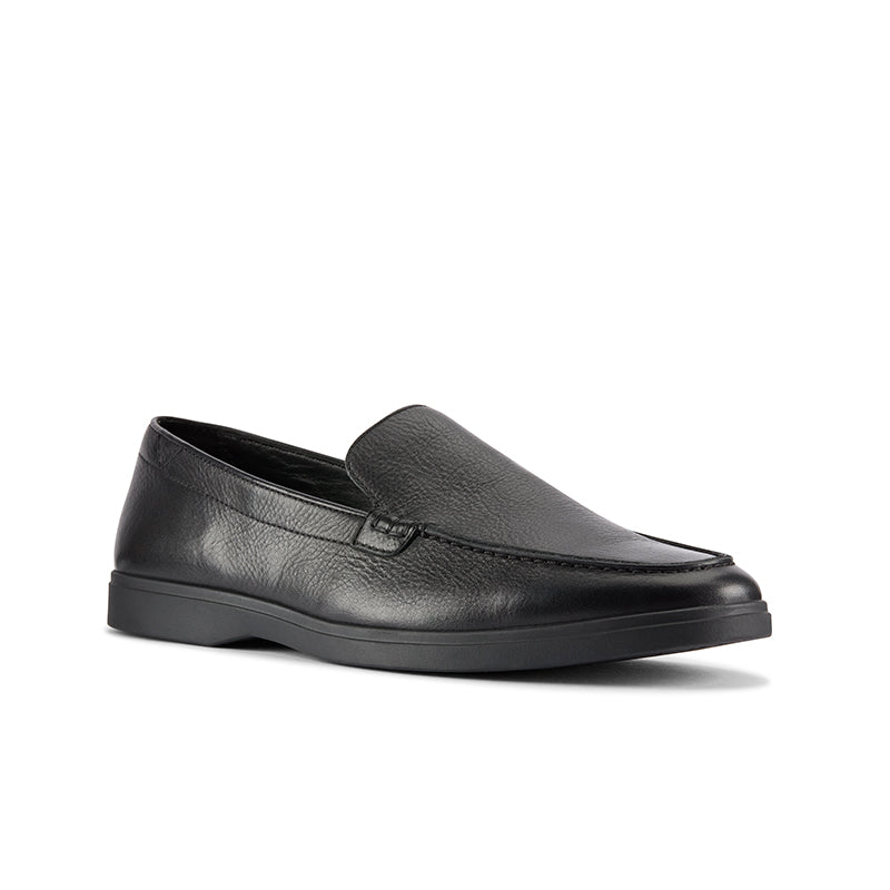 Leather slip-on loafers with moc seam detail, black upper and dark rubber outsole.