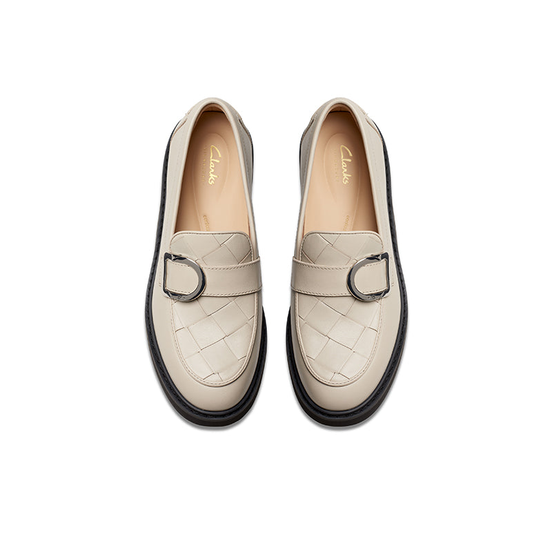 Pair of beige leather penny loafers with metal buckle hardware and stitched vamp