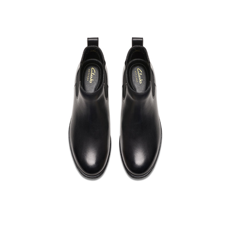 Pair of women’s black leather ankle boots with elastic gores and low heel