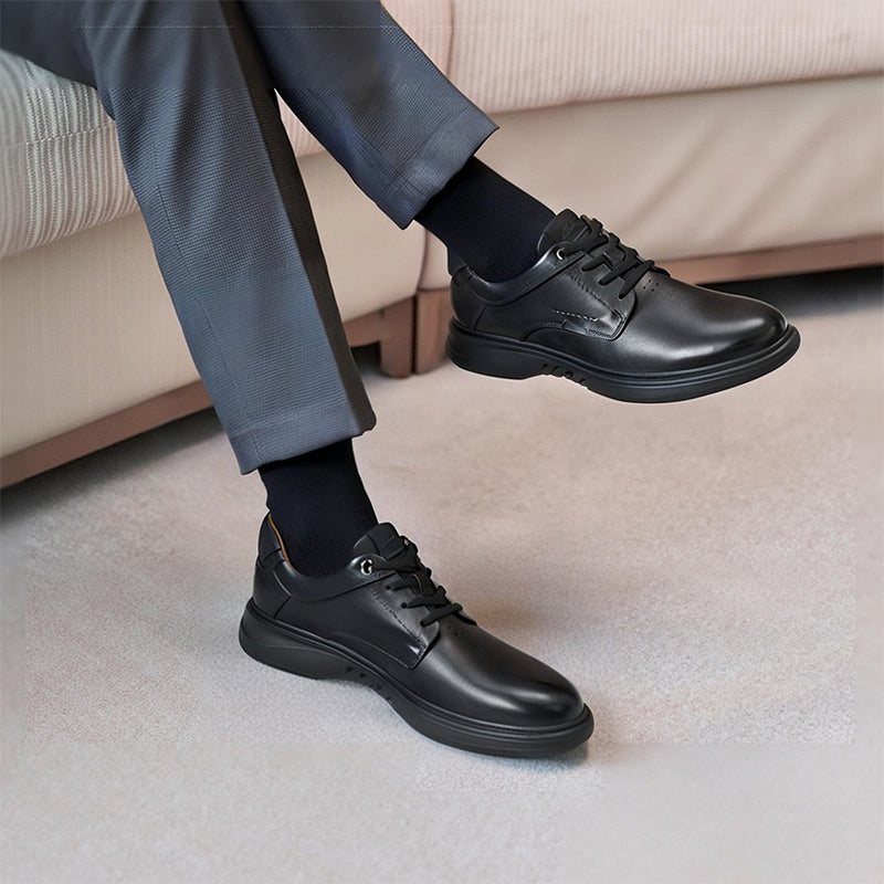 Men's black leather lace-up business shoes on feet with low-profile sole