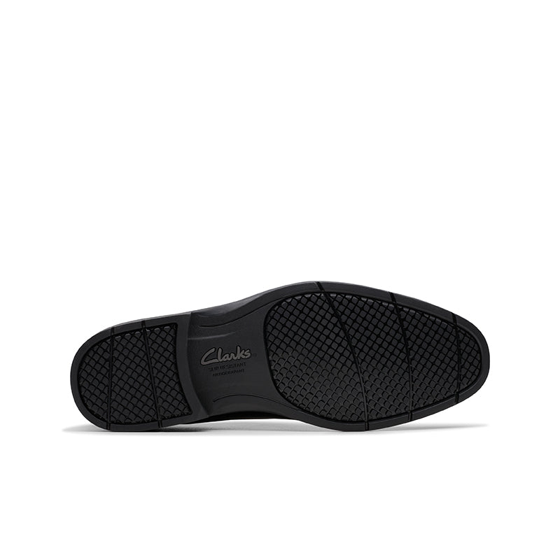 Black shoe outsole with textured tread and Clarks logo
