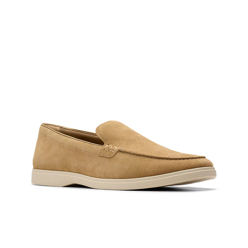 Suede slip-on loafers with moc seam detail, tan upper and light beige outsole.
