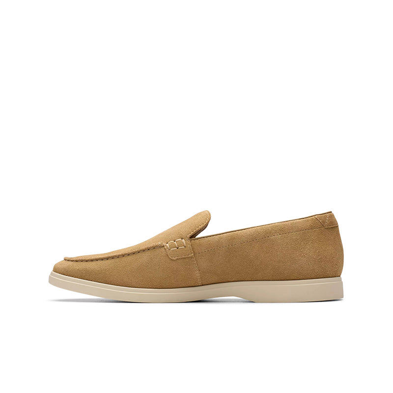 Suede slip-on loafers with moc seam detail, tan upper and light beige outsole.