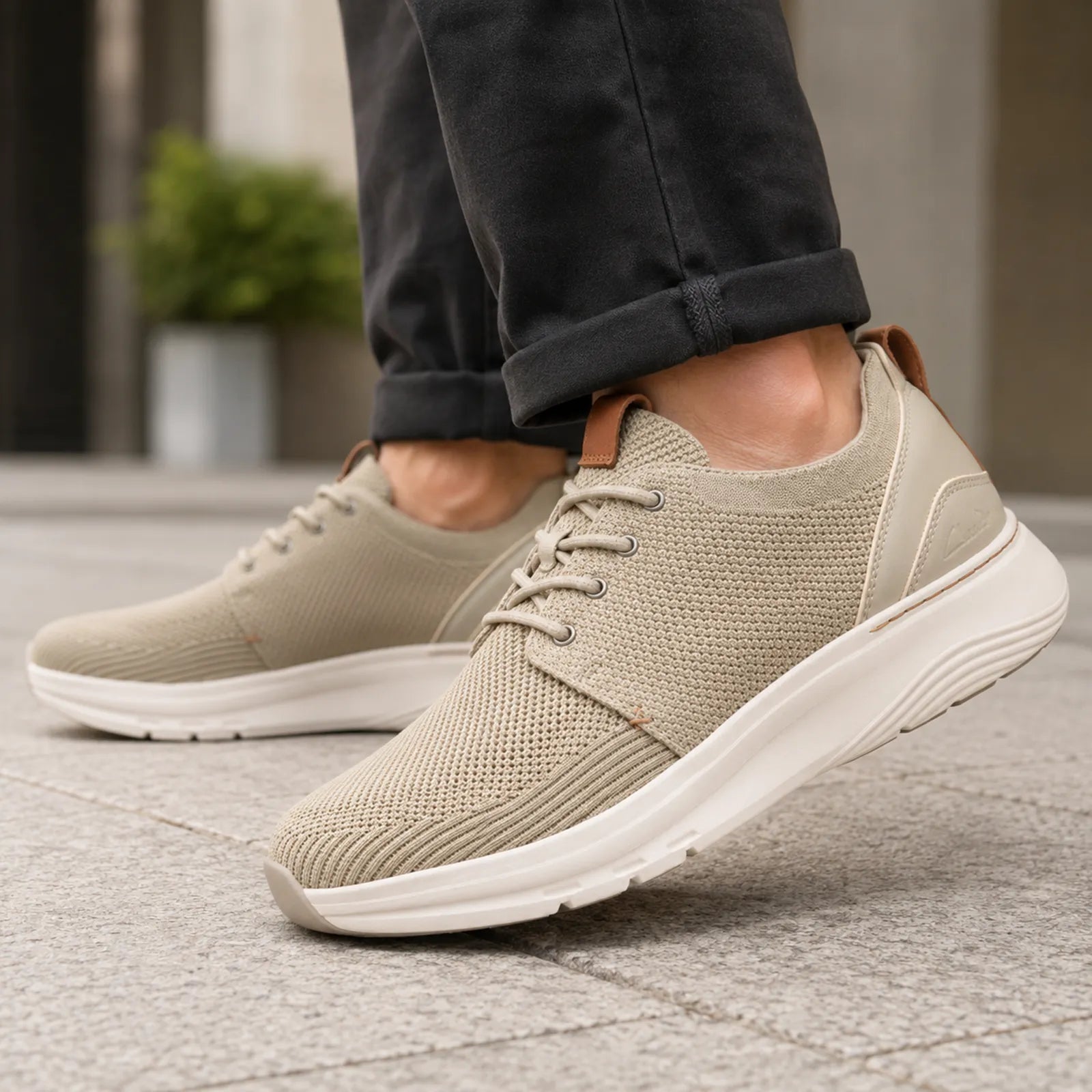 Men's light beige lace-up sneakers with textured knit upper and white sidewall sole