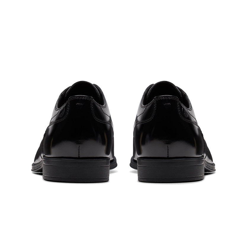 Black leather lace-up business shoe back view with low stacked heel