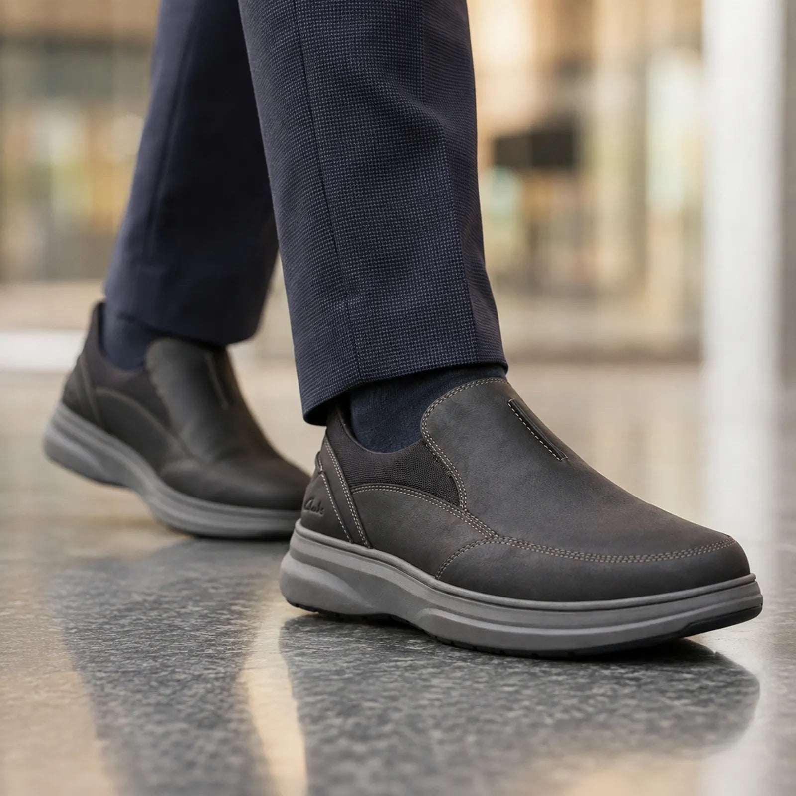 Close-up of men's black leather slip-on shoes with thick rubber sole