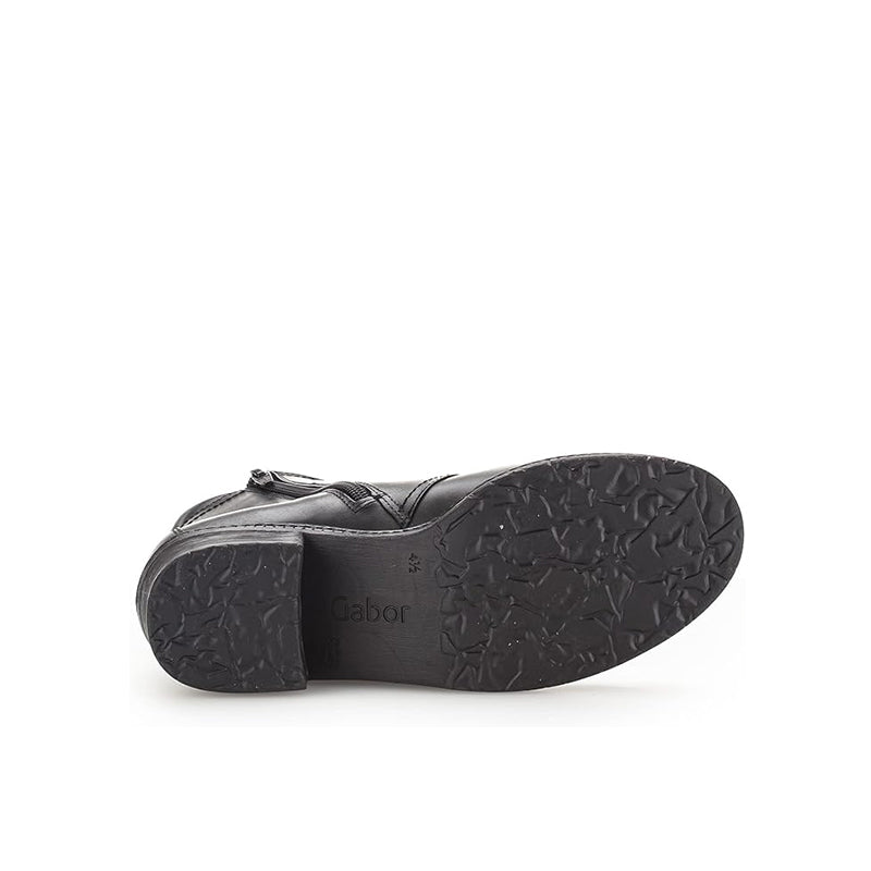 Rubber outsole of dark ankle boot with textured tread and Gabor logo