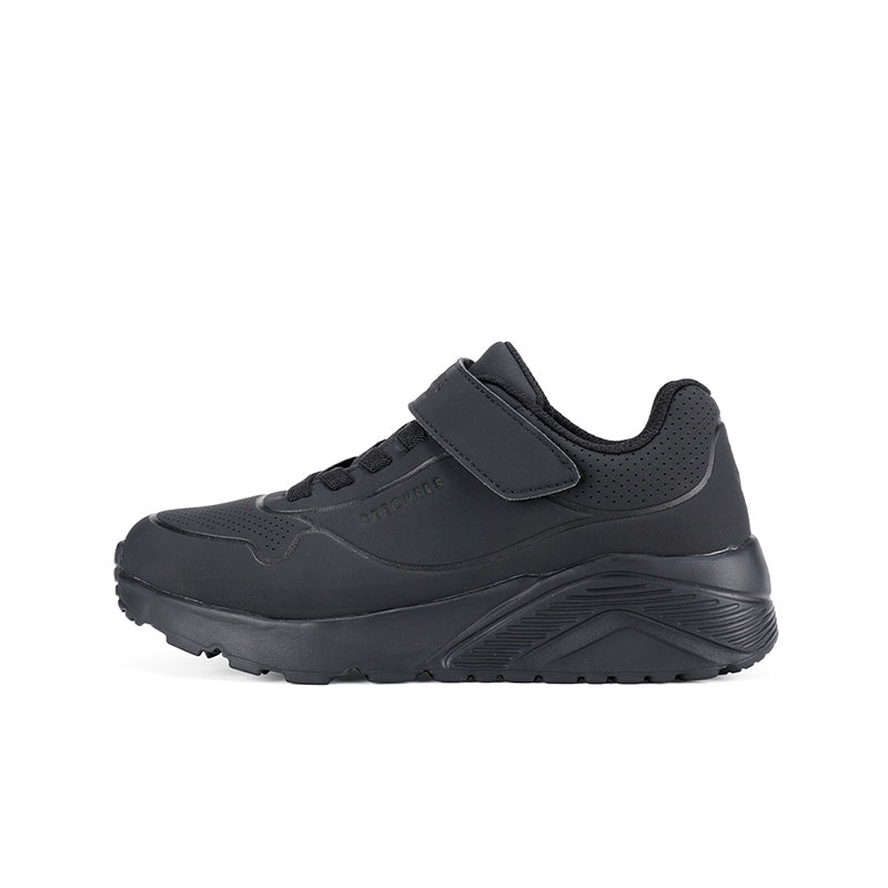 Boys black sneaker side view with hook-and-loop strap and textured midsole