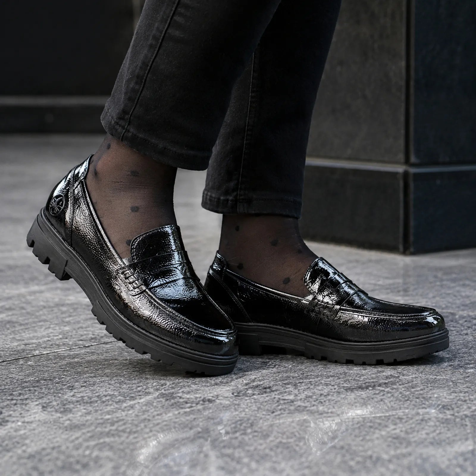Rieker women's black patent loafers worn with smart casual outfit, comfortable slip on shoe style